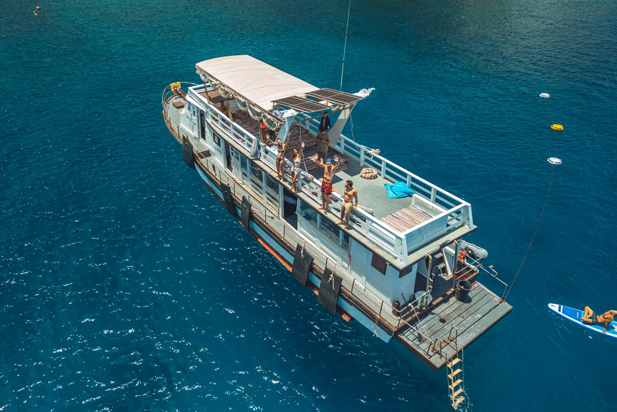 Freedivers in the water beside the Blue Chitta boat