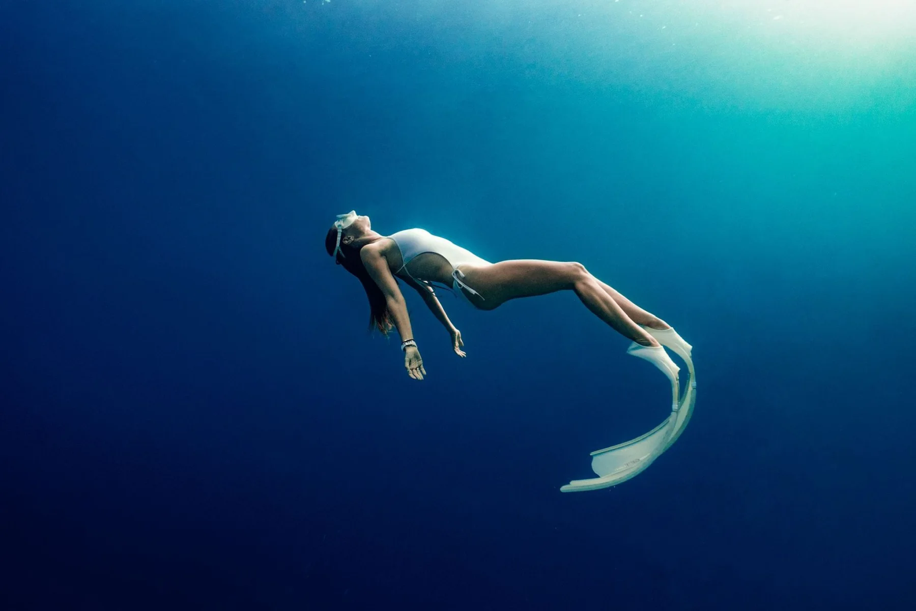 A freediver in clear blue water
