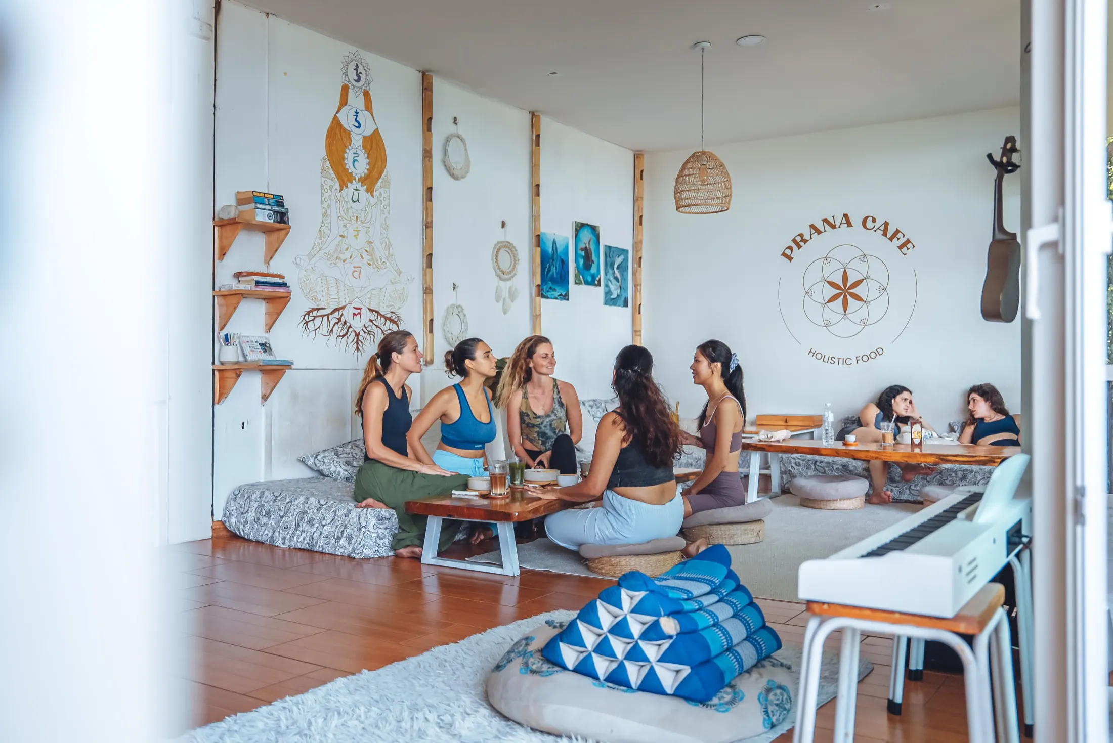 Guests relaxing on floor cushions inside Prana Café