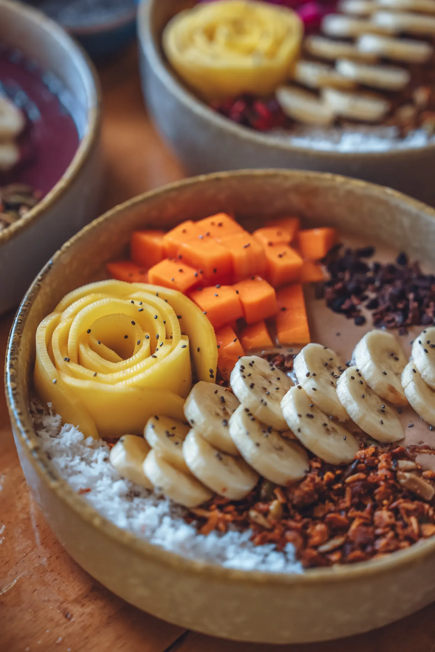Close-up of a smoothie bowl topped with mango and banana